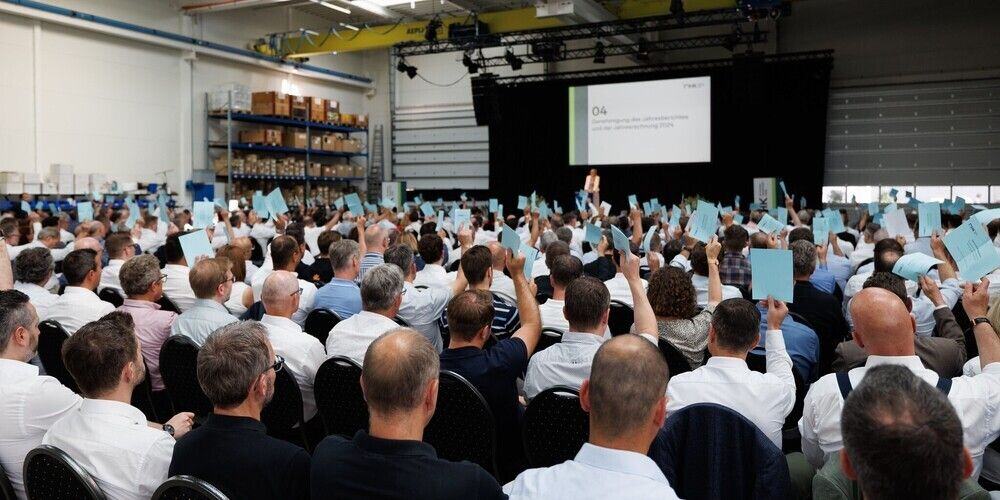 Filenames: large-conference-audience-raising-hands.jpg.