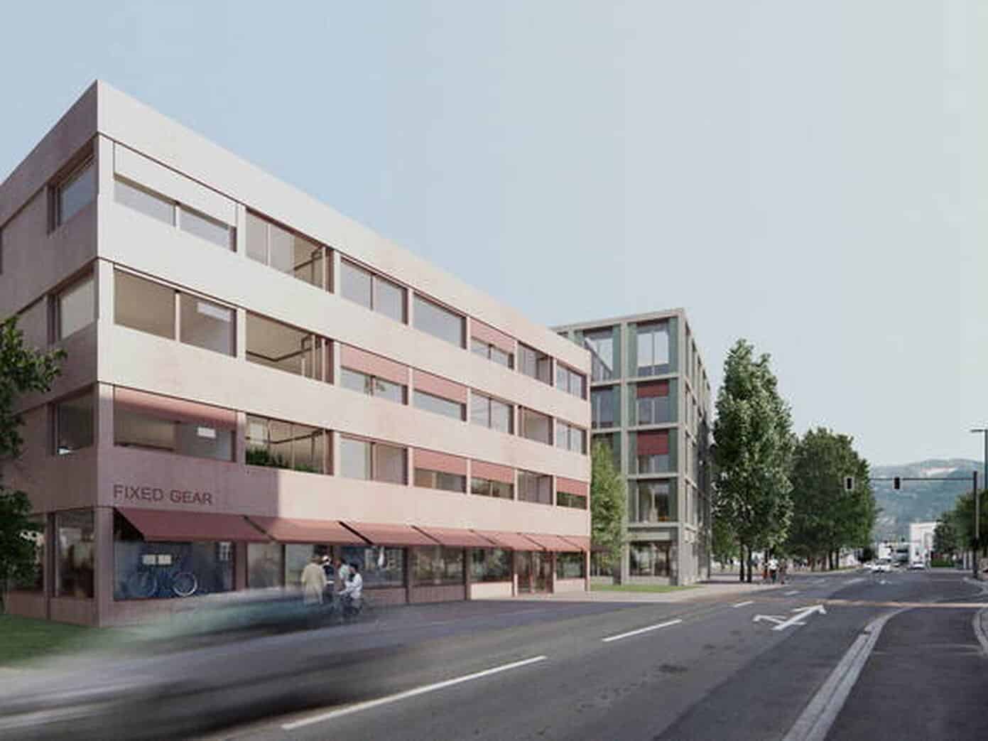 Modern multi-story commercial building with large glass windows and a street view, featuring a retail store on the ground floor. The scene includes trees lining the street and a clear sky overhead.